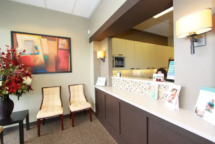 a reception desk in a waiting room of bellevue dentist at bellevue prime dental group with a relaxing design