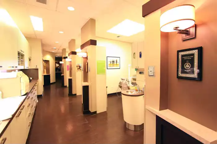 a hallway with white walls and a light fixture of bellevue dentist in bellevue prime dental group