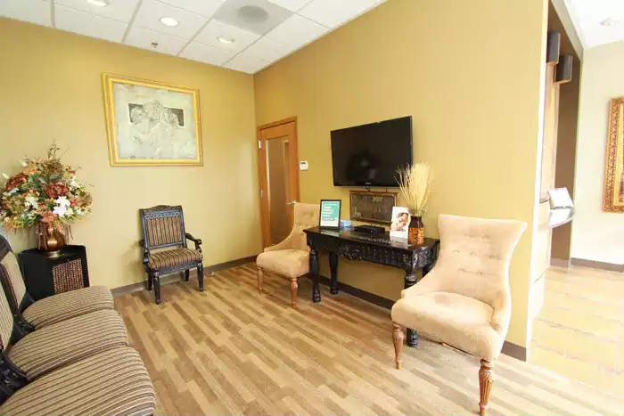 Comfortable waiting room with a television and chairs in lynnwood dentist at Lynnwood Prime Dental Group