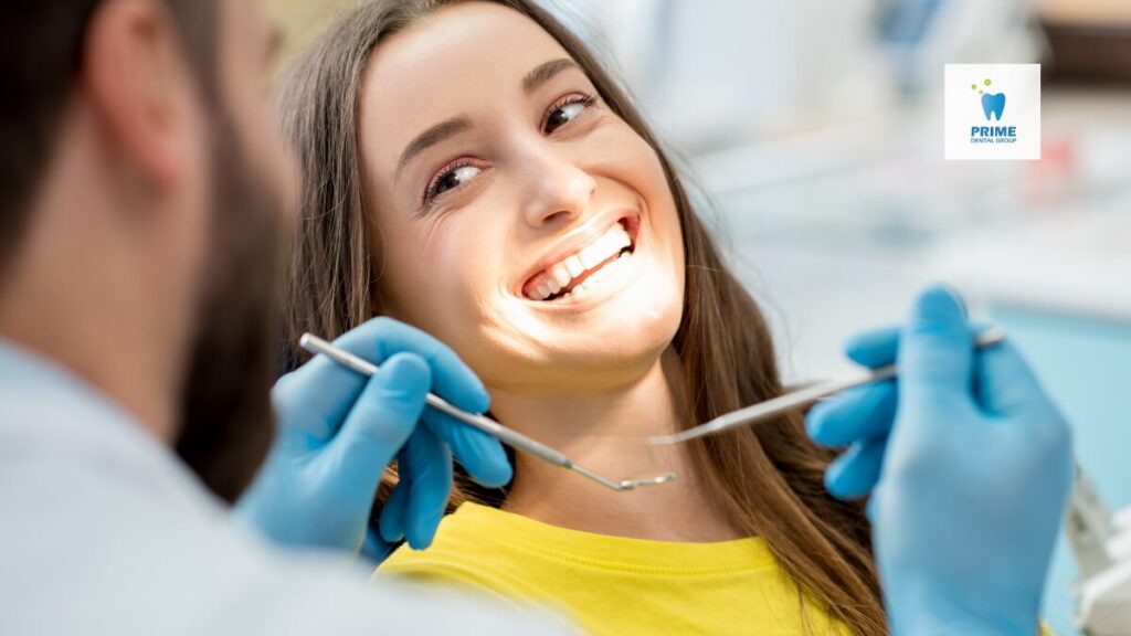 Smiling woman at a dental checkup, emphasizing year-end benefit use.