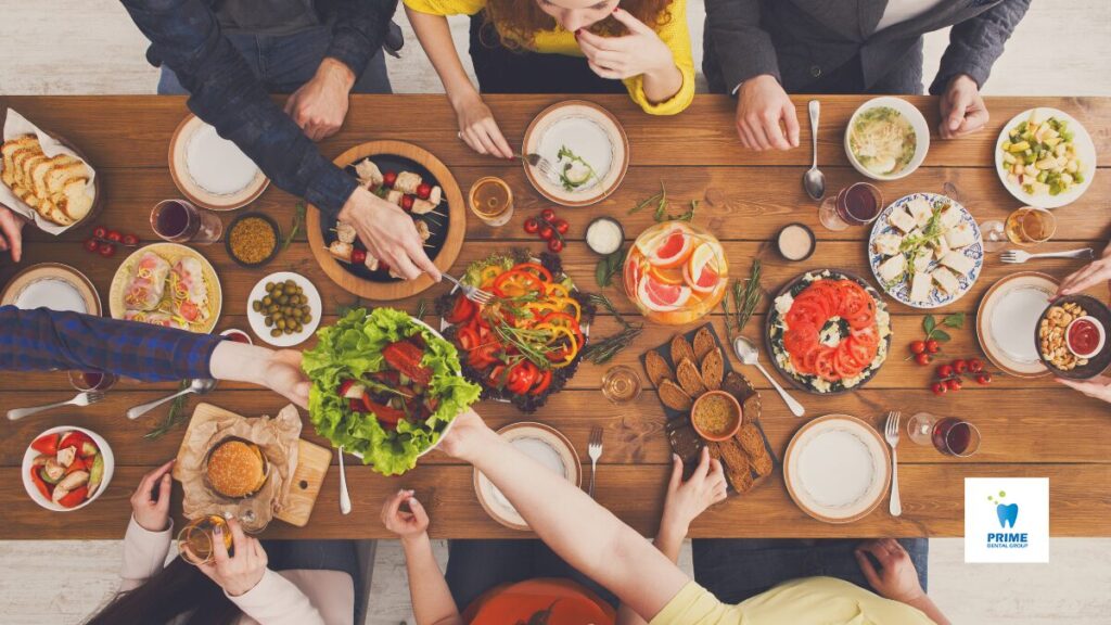 Top view of a group sharing a holiday meal with healthy dishes.