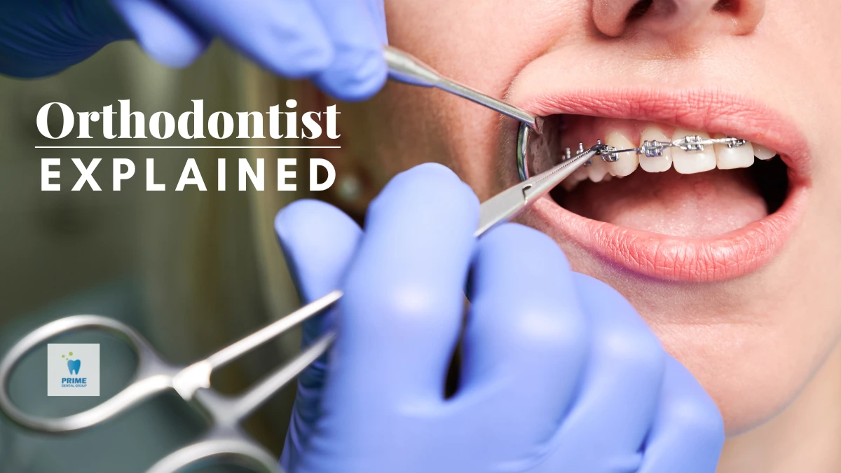 A close-up of an orthodontist adjusting metal braces on a patient's teeth using dental tools.