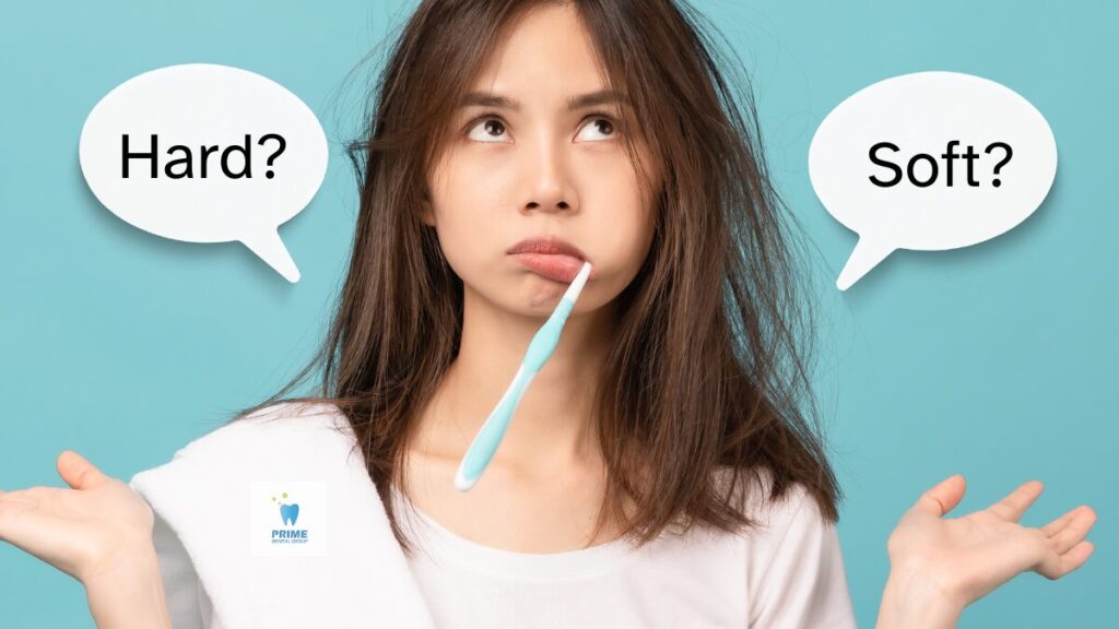 Woman pondering toothbrush choice with "Hard?" and "Soft?" speech bubbles